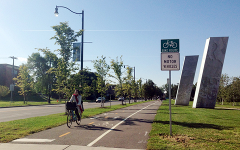 Woman biking along path in Buffalo, NY