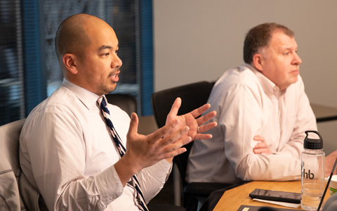 Will Dungo at a conference table with colleagues