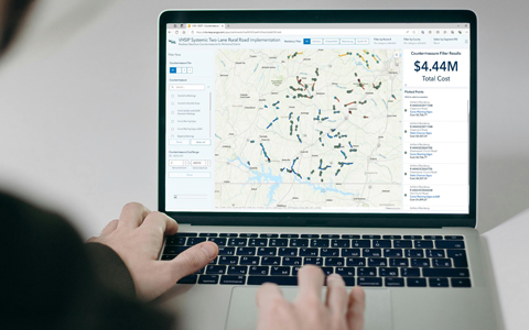 A laptop computer shows an ArcGIS dashboard with countermeasure locations and cost estimates.