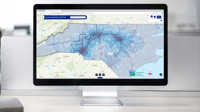 A desktop computer showcases the drive time layer in the web-based app.