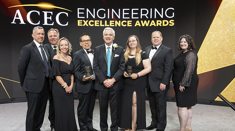 VHB employees stand with ACEC award