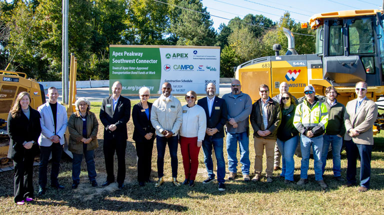 The consultant project team holds shovels to move dirt at the groundbreaking.