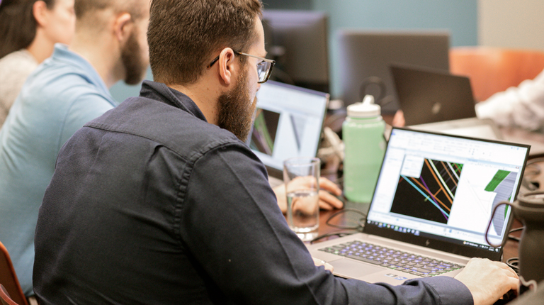 A group of trainees looking at laptop computers.