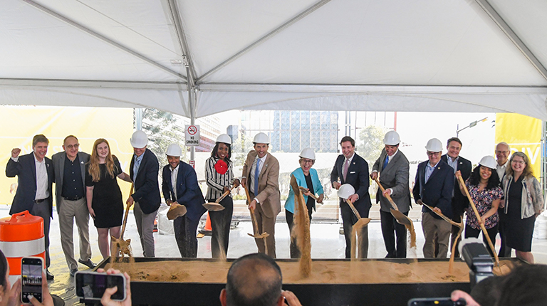 Key team members break ground at the ceremony.