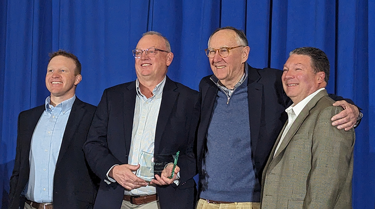 Image of award recipients smiling at the camera