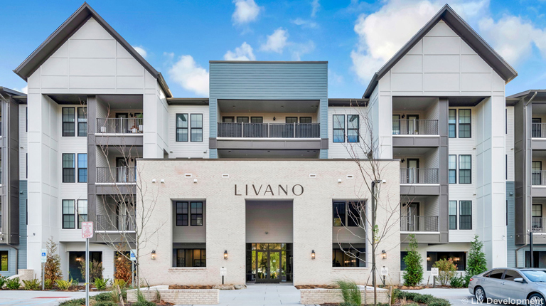 The Livano Apartments entrance building façade with plantings.