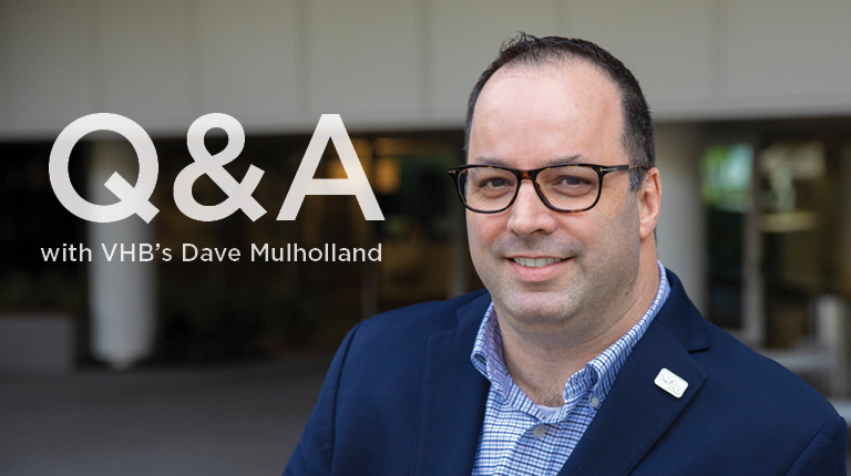 Dave Mulholland standing outside wearing a navy blue blazer and checkered shirt.