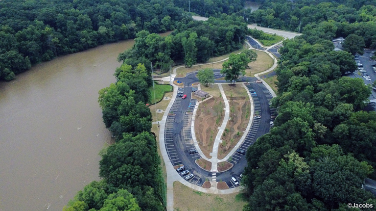A bird’s eye view of a park along a river.