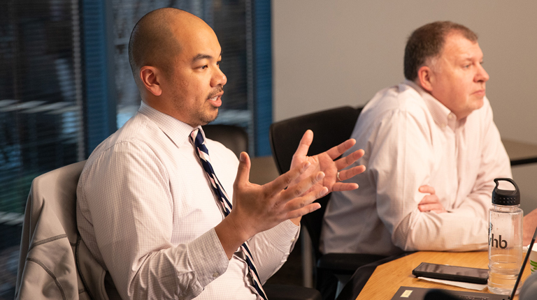 Will Dungo at a conference table with colleagues