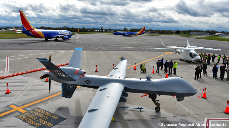 A group of airplanes on a runway. 