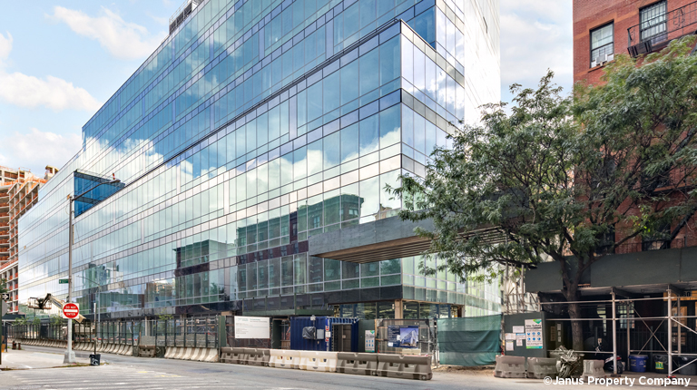 Glass building seen from the street level.