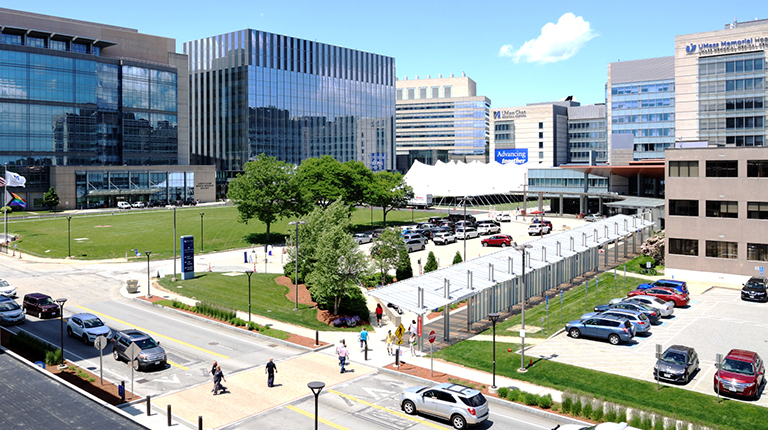 Image of UMass parking lot and pedestrians