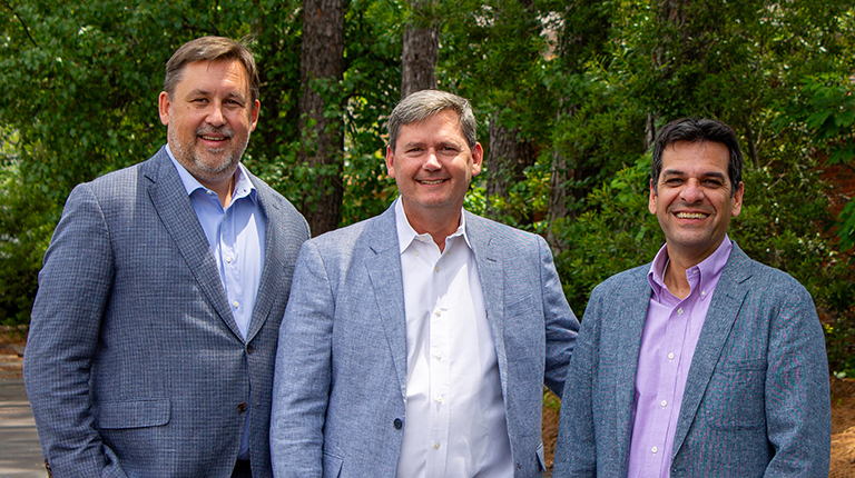 VHB and new employees from Urban Engineers stand together outside