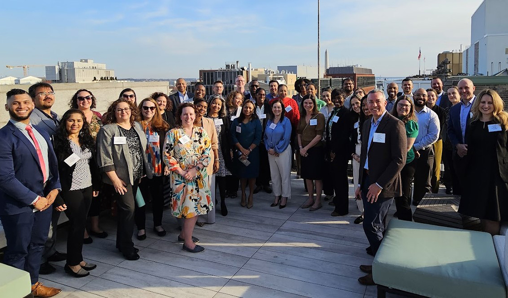 A group of people standing on a rooftop.