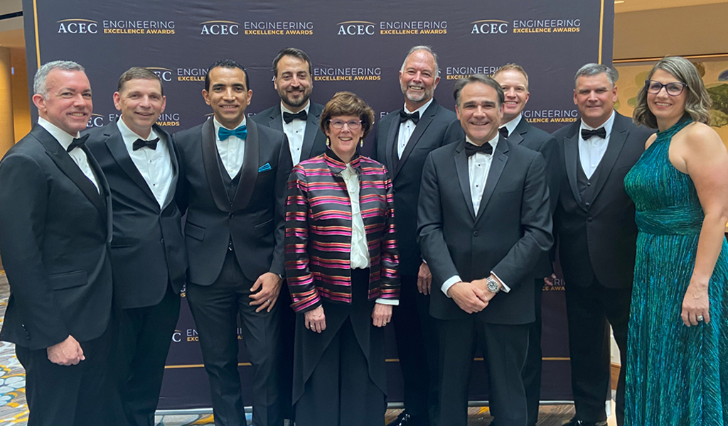 A group of VHBers stand together at the awards ceremony smiling at the camera. 