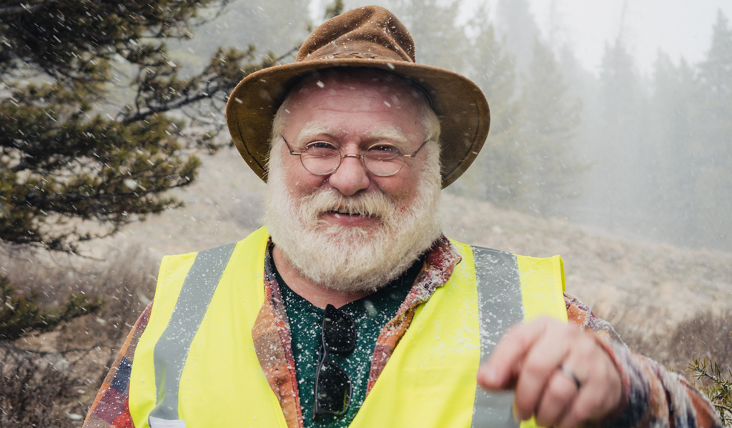 Alex smiling wearing a safety vest.