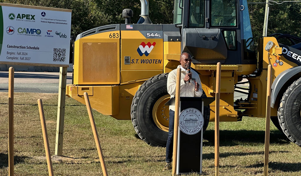 A speaker stands at the podium at the groundbreaking ceremony.