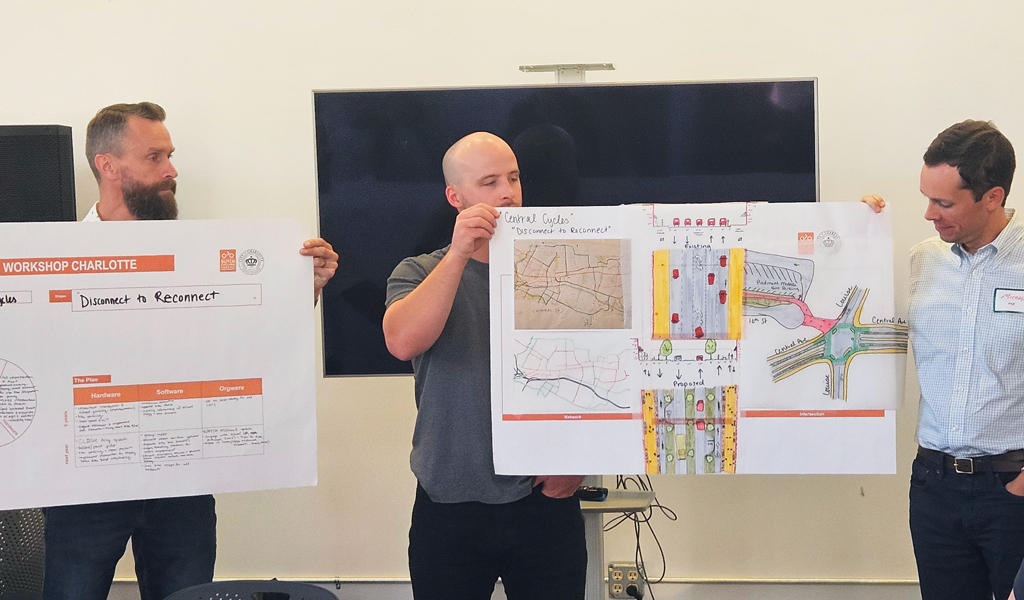 Three workshop participants present final group concepts.