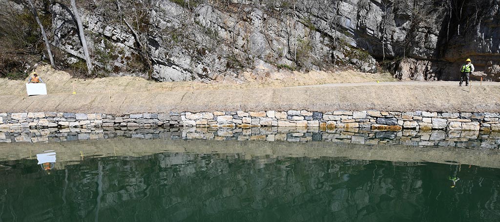 After image shows repaired rock wall and restored embankment.