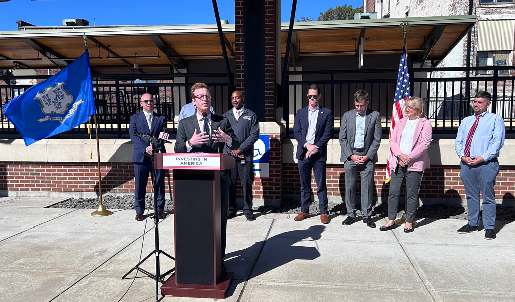 USDOT representative speaking at podium at CTDOT Unified Mobility App launch.