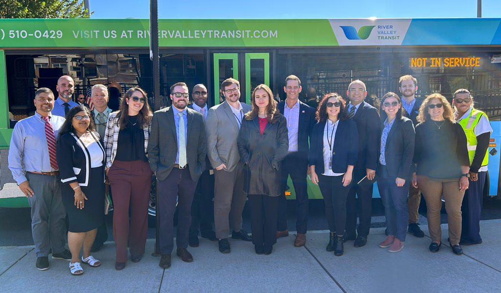 Group of people in front of River Valley Transit bus at the CTDOT Unified Mobility App launch.