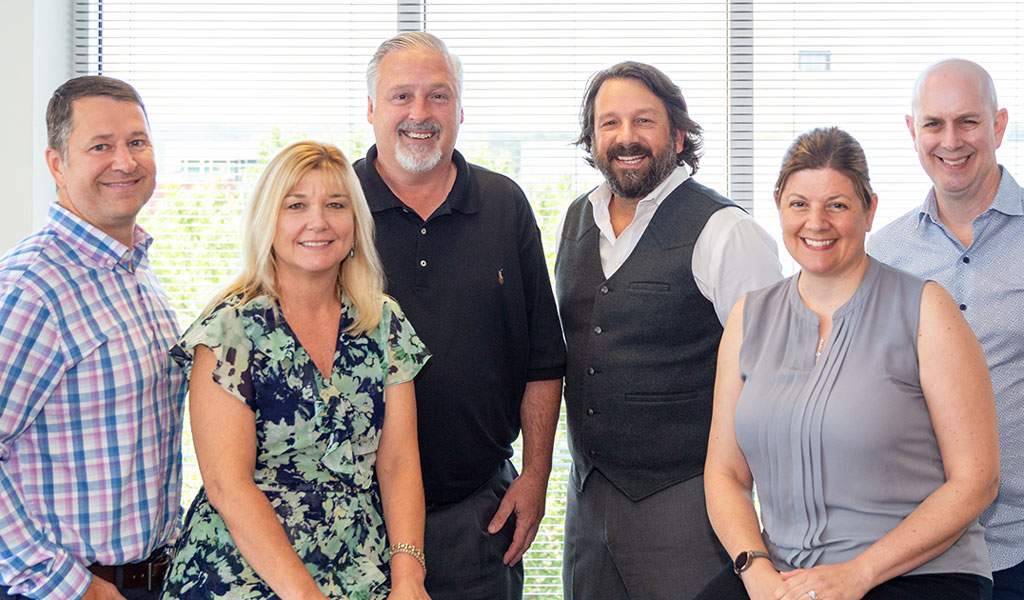 Six members of the Energy Evolution Practice sitting together and posing for a group photo.