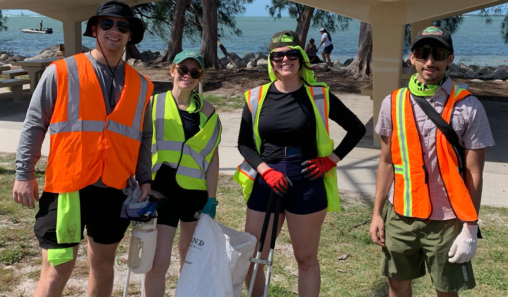 Group of four VHBers pausing their cleanup efforts.