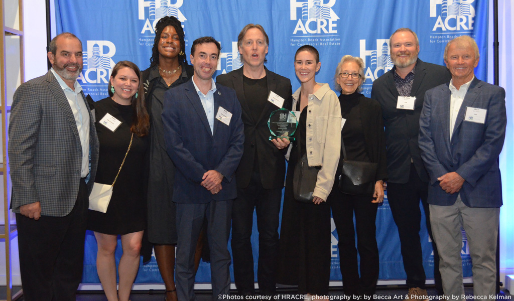 J.D. Hines stands with eight members of the project design team. 