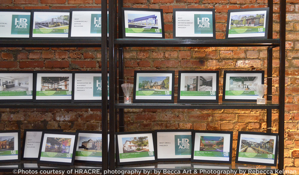 A shelf holds the 2025 HRACRE design awards. 