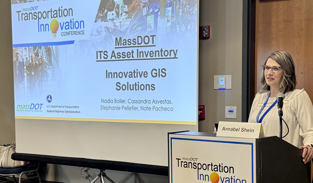 Person presenting a slide titled "MassDOT ITS Inventory and Innovative GIS Solutions" with additional transportation images and text.
