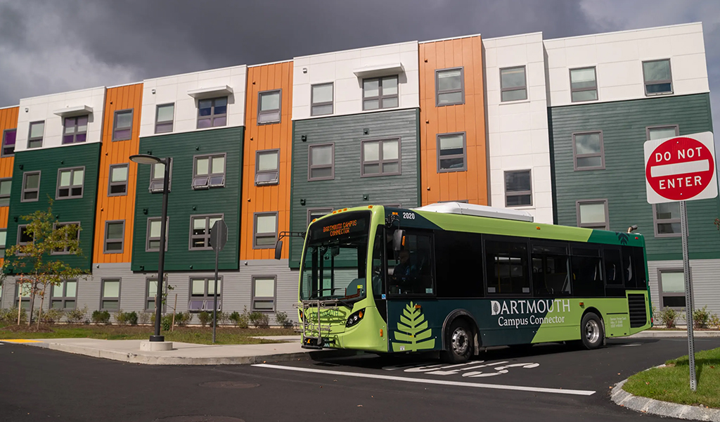 Summit at Juniper Hill graduate student housing building and Dartmouth Connects bus.