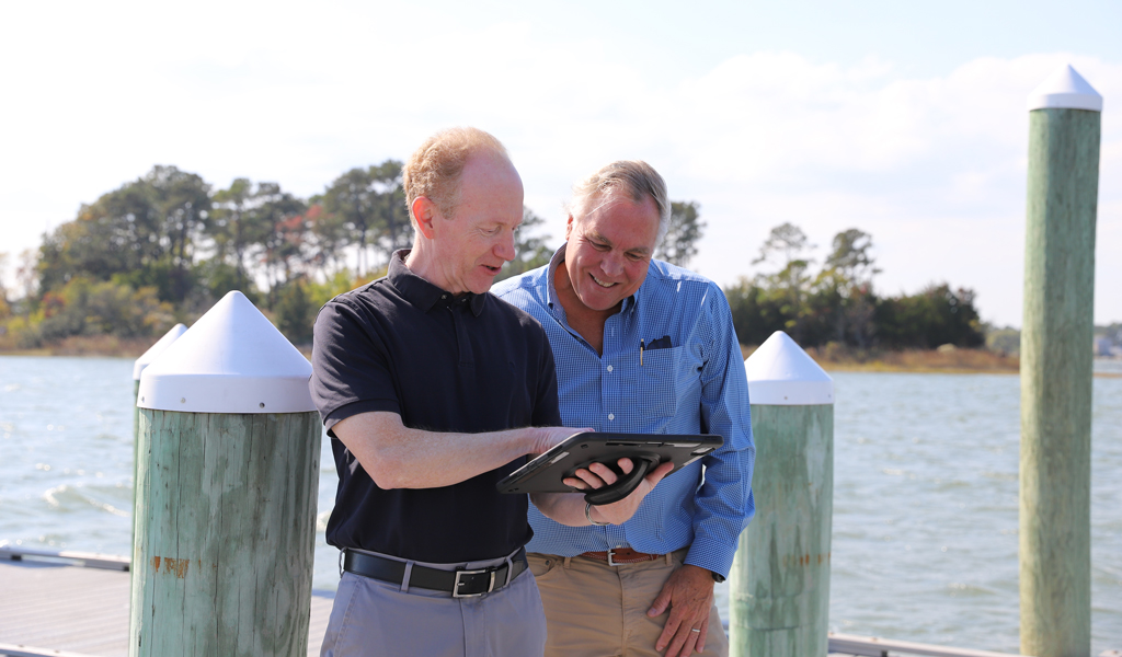 Neville and Chris DeWitt make a site visit with a tablet to capture project details.