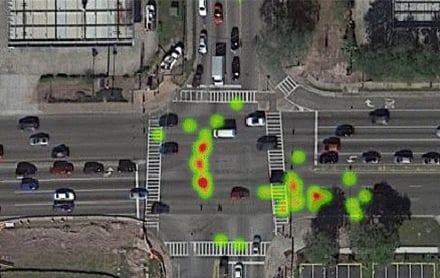 An aerial view of a heat map of a roadway intersection showing clusters of near-misses.