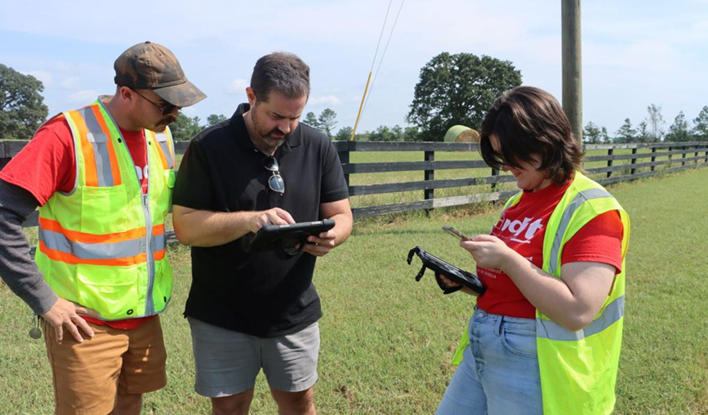 Patrick and colleagues conducting field work outside.
