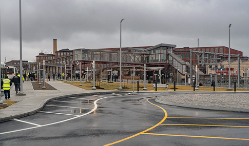 Brick train station with glass windows and sidewalks.