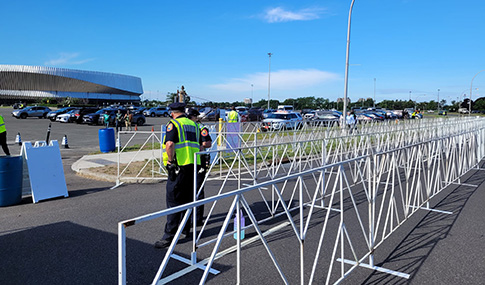 Fans traveling through parking lot to cricket stadium