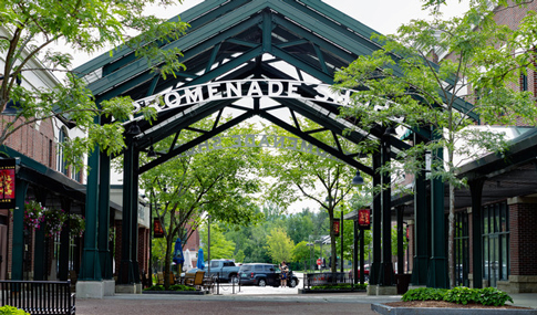 A peaked entrance monument flanked by trees.