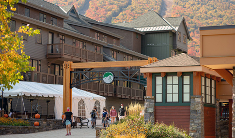 A mountain resort with fall-colored mountains in the background.