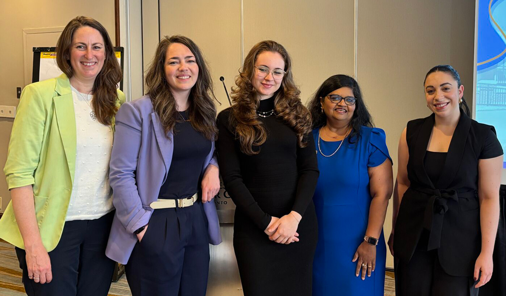 Five professionals standing in front of a presentation screen with the CTDOT logo, at a conference dated May 7, 2025.