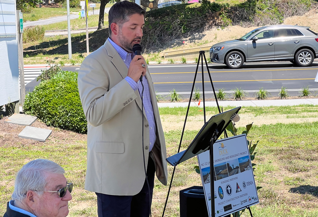 Ricky Wiatt speaks into a microphone at the project’s ribbon cutting ceremony.