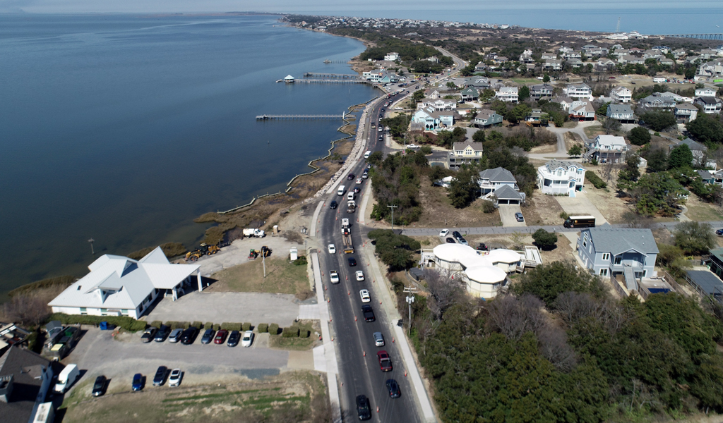 Vehicles drive along the new section of roadway a month before construction completion.