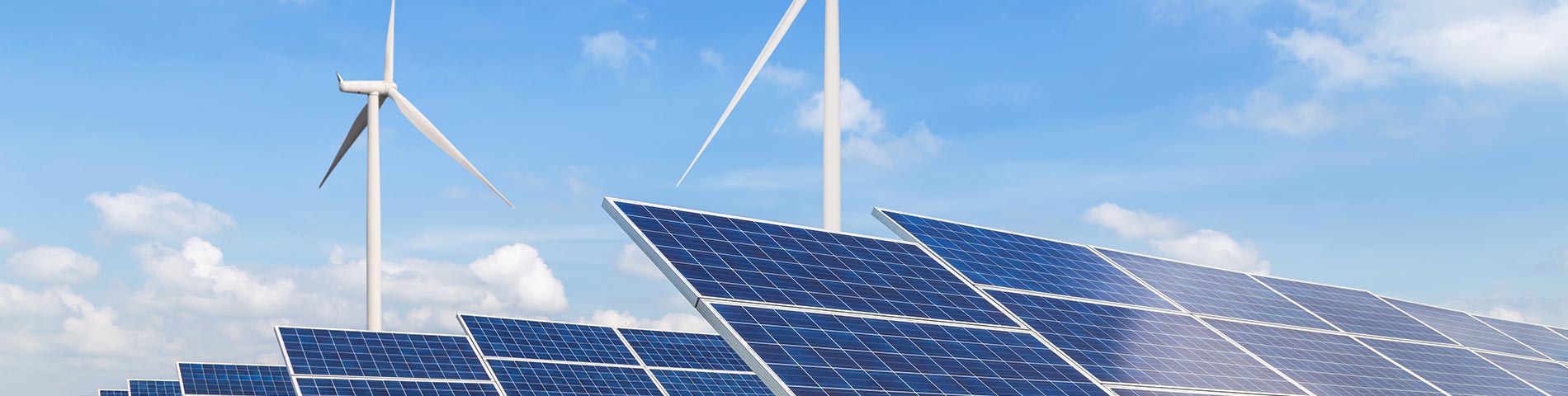 solar panels and wind turbines generating electricity in power station green energy renewable with blue sky background