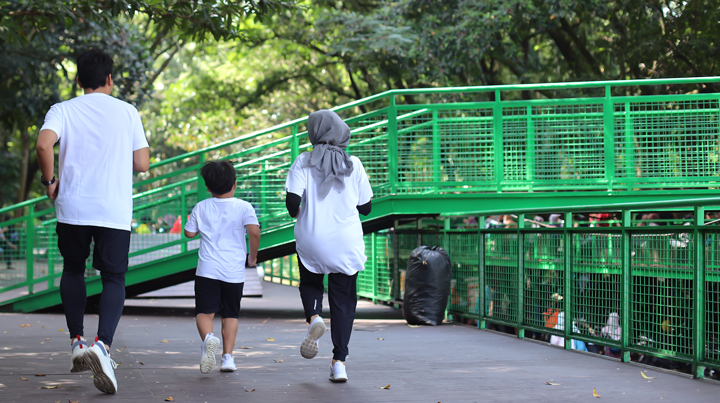 A Muslim family jogging in a park