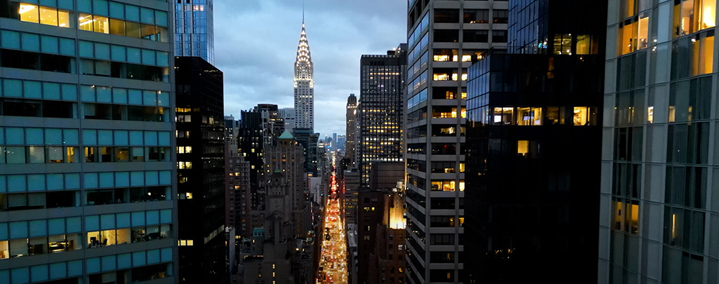 Panning down New York City office buildings at dusk.