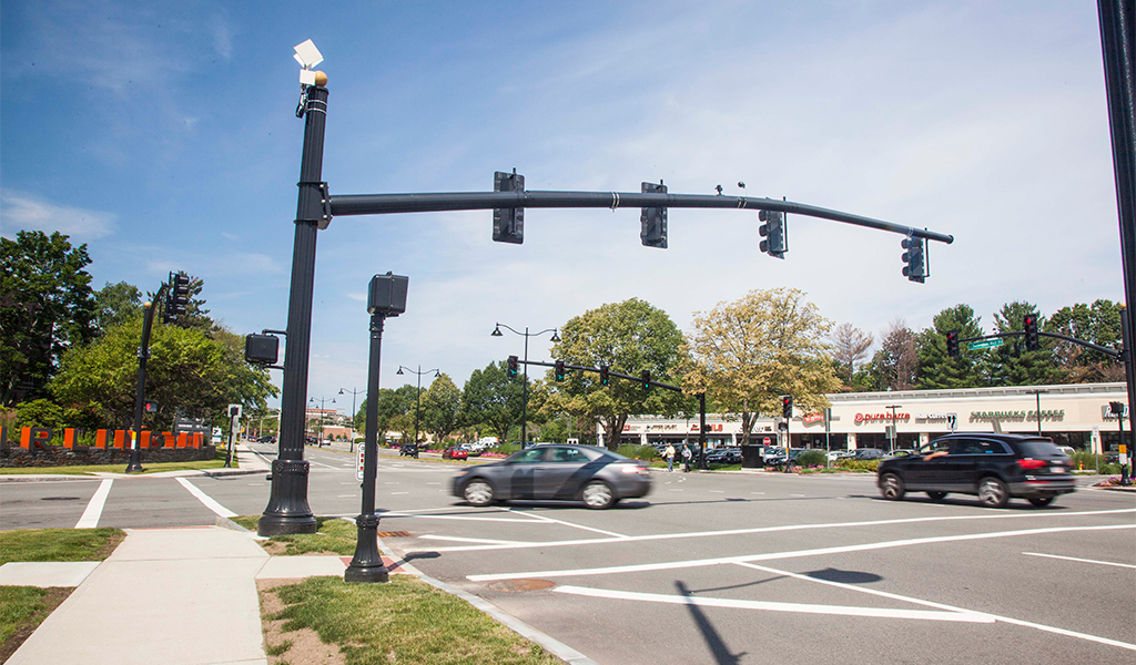 Photo of cars making a left turn at an intersection. 