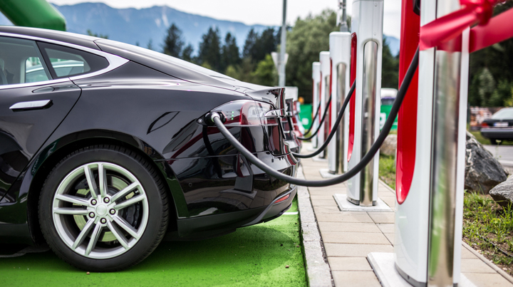 An electric vehicle plugged into a charging station.