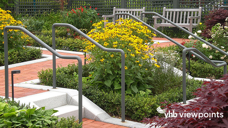 Outdoor garden with robust flowers, brick walkways, and benches.