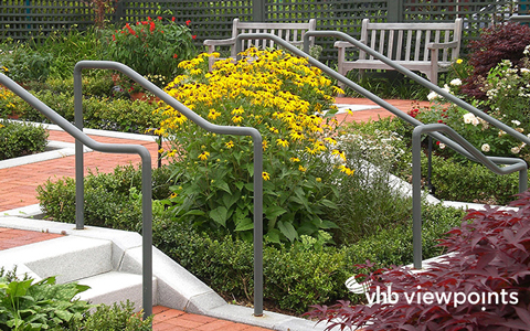 Outdoor garden with robust flowers, brick walkways, and benches.